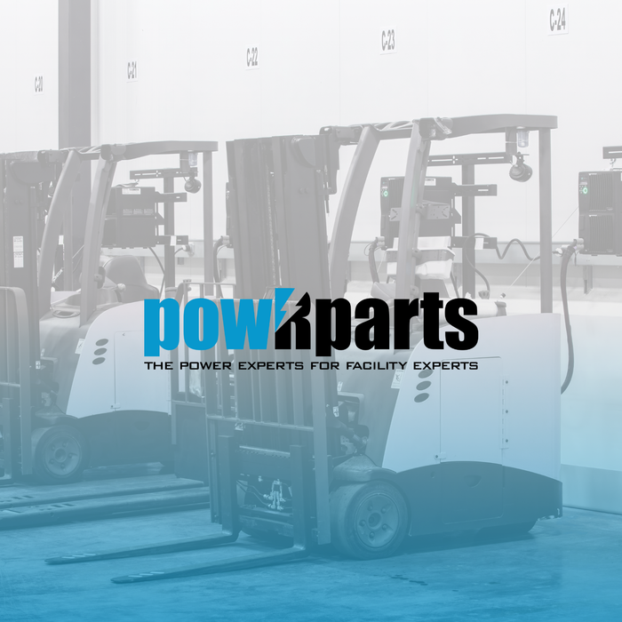 Electric forklifts charging at facility power stations in warehouse setting