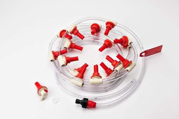 Battery watering system with clear tubing and multiple red injector valves on white background