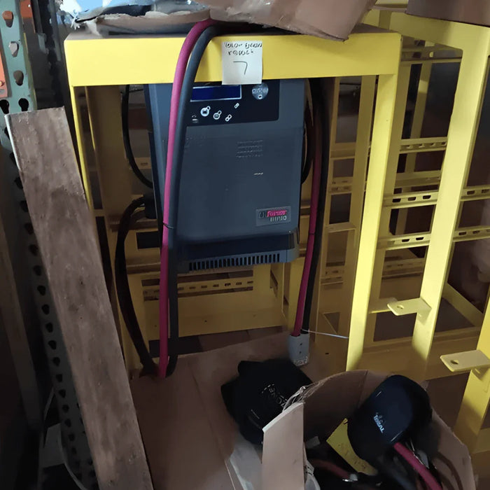 Enclosed EnerSys IMPAQ battery charger on yellow stand with attached power cables