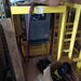 Enclosed EnerSys IMPAQ battery charger on yellow stand with attached power cables