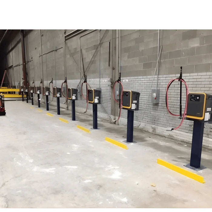 Industrial battery charger stands with control panels and cables in a warehouse setting