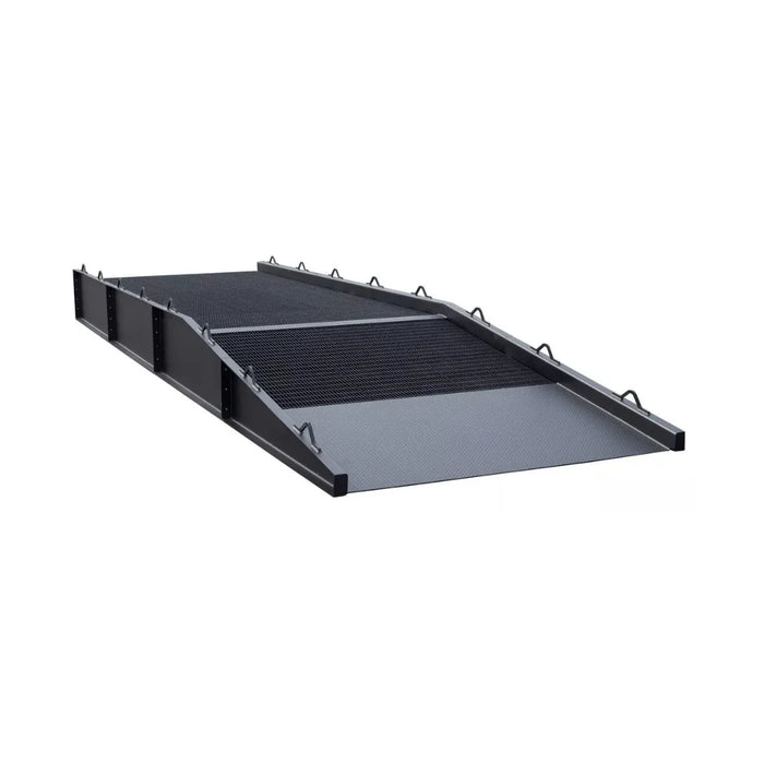Heavy-duty steel loading dock ramp with textured non-slip surface and safety rails